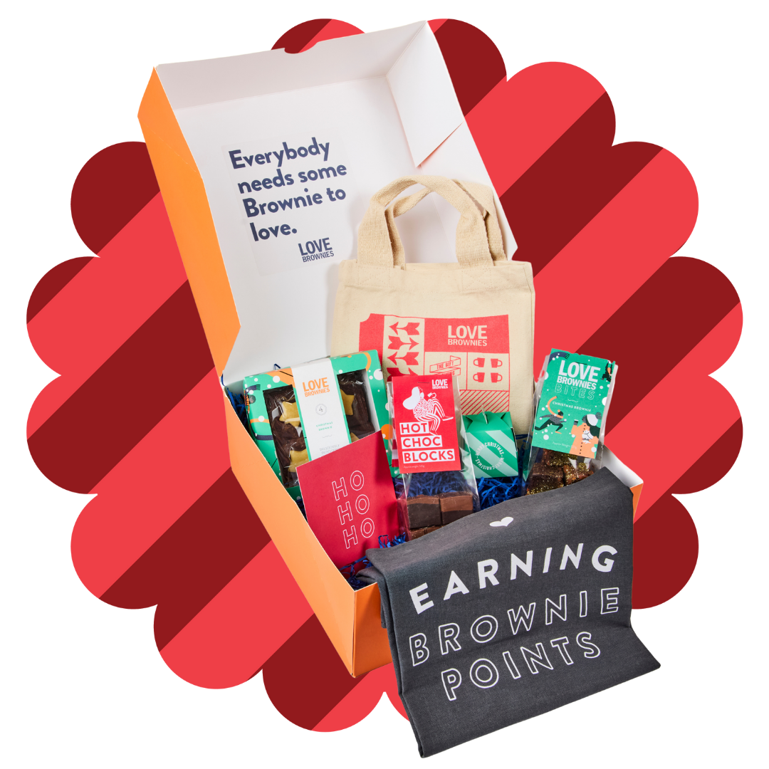 Orange hamper with hot chocolate blocks, grey tea towel, small tote bag, chocolate brownie bites, gift box of gluten-free christmas brownies