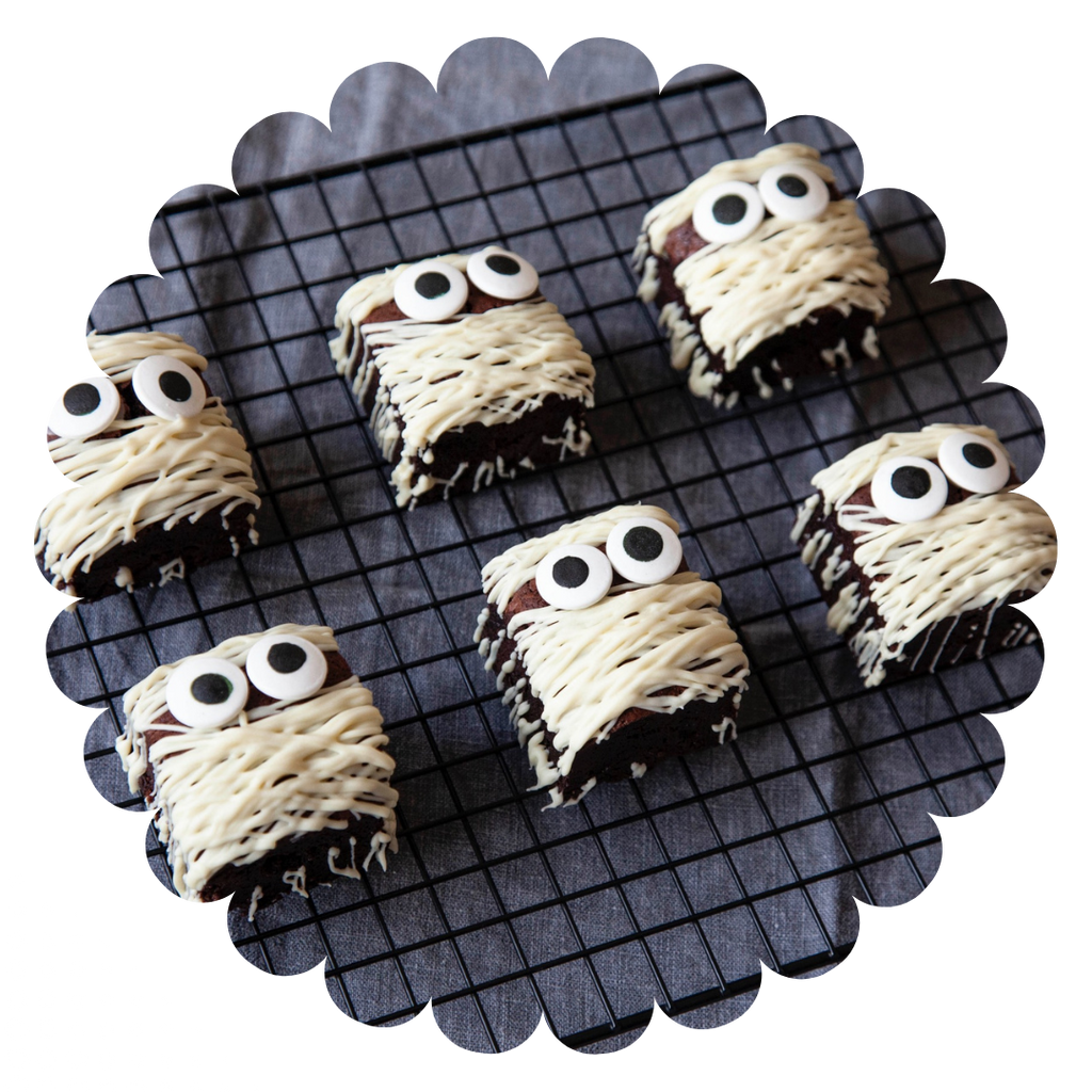close up of gluten free chocolate halloween mummy brownies with white chocolate icing