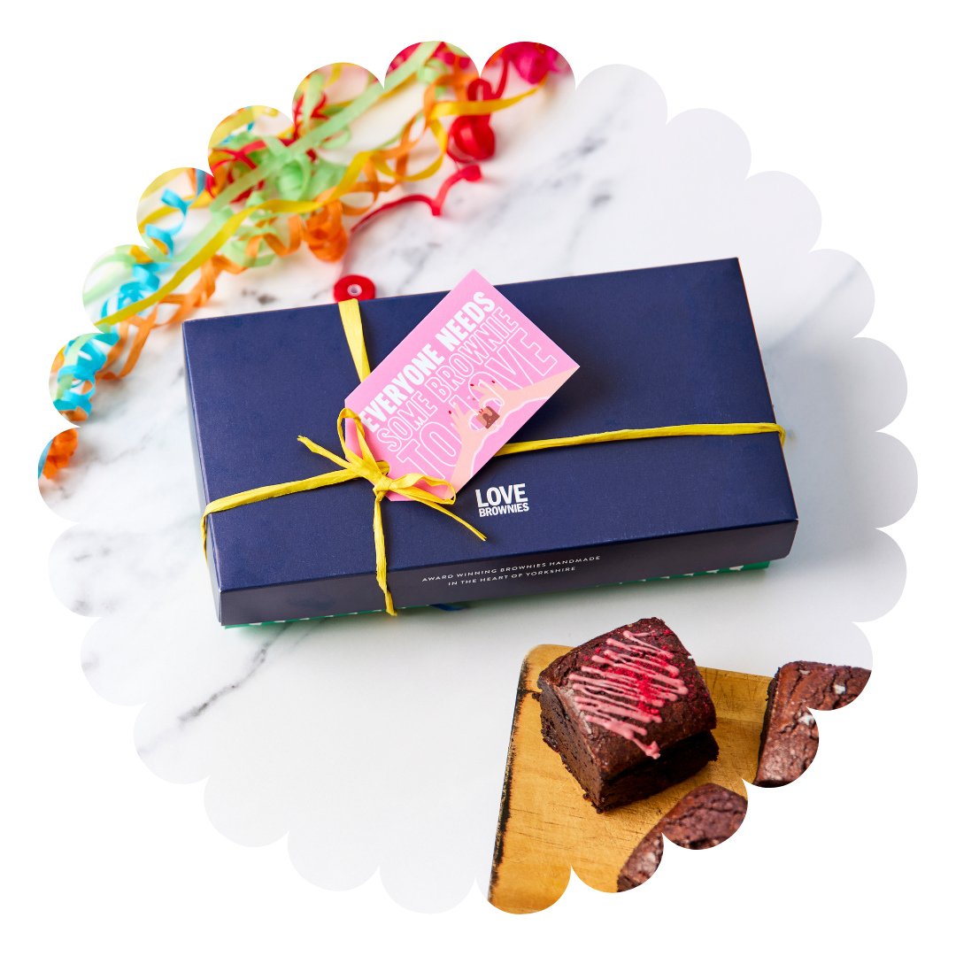 
                  
                    Navy gift box with yellow raffia ribbon and handwritten personalised gift tag and gluten free and nut free raspberry chocolate brownies
                  
                