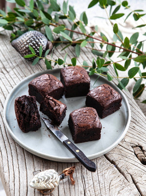 Christmas gluten free brownies on a plate with Christmas foliage